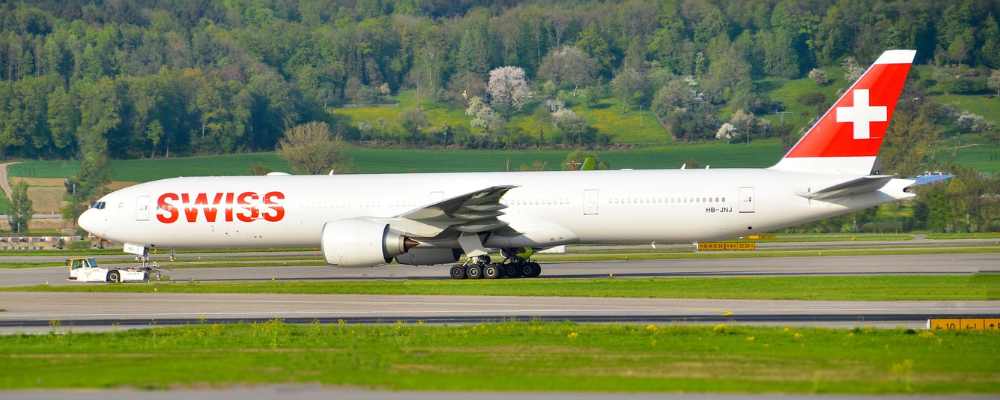 A swiss plane standing at a airport due to flight cancellations 