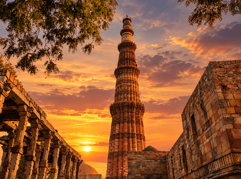 Qutub Minar framed through a stone arch